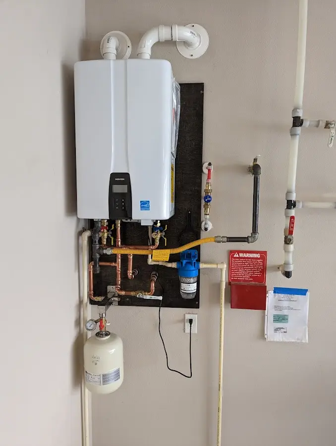 Professional plumber installing copper piping in a Underhill home